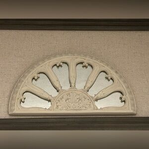 Wall pediment with mirror inlay.
